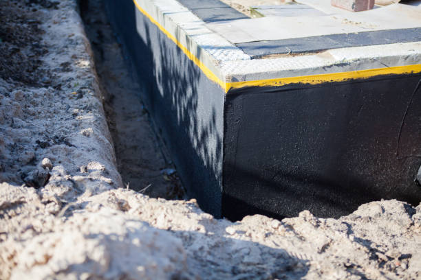 Professional Basement Waterproofing technician working in Farmer, OH